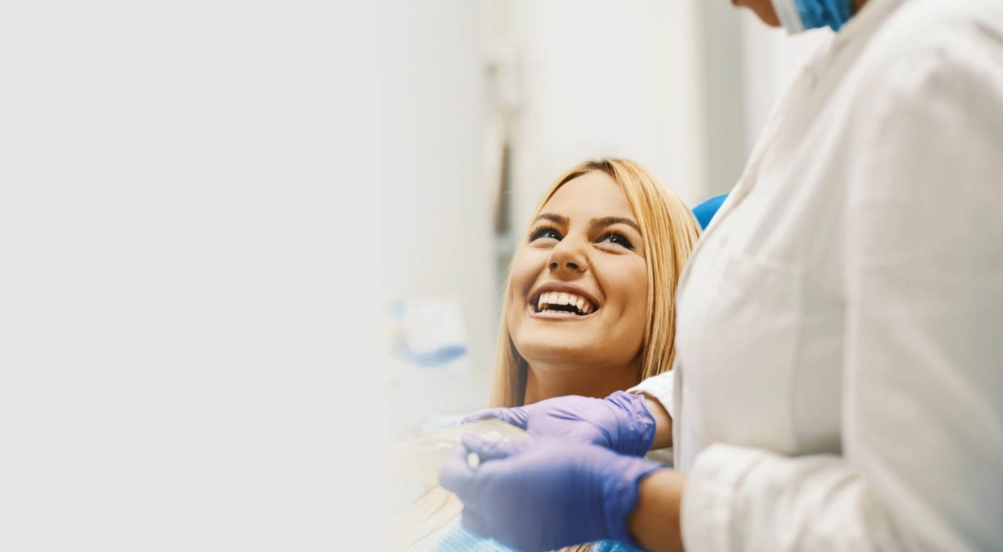 Smiling patient looking up at her dentist